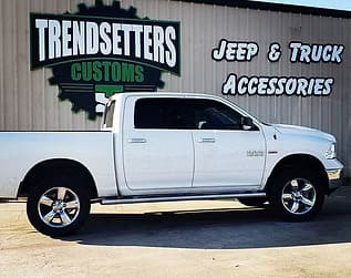 Custom white pickup truck with chrome wheels at Trendsetters Customs.