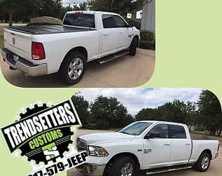 White customized pickup truck with black accents and aftermarket wheels.