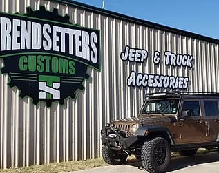 Trendsetters Customs sign on building with Jeep and truck accessories.