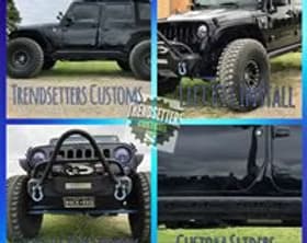 Custom off-road vehicle with lifted suspension and rugged tires.