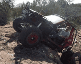 Custom off-road Jeep vehicle navigating rugged terrain.