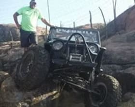 Customized off-road Jeep with large tires and rugged modifications.