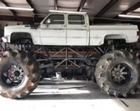 Monster truck with custom lift and huge tires for off-road performance.