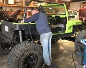 Custom off-road vehicle being built with professional tools at Trendsetters Customs.