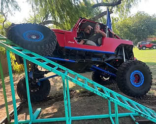 Custom off-road Jeep with large tires and lifted suspension at Trendsetters Customs.