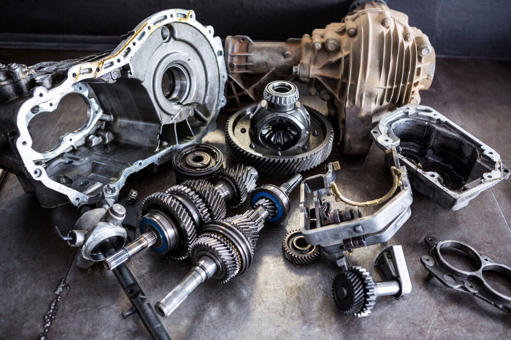 Disassembled off-road vehicle parts including gears and transmission components for custom 4x4 upgra.