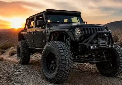 Custom off-road Jeep by Trendsetters Customs in desert sunset.