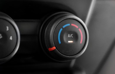 Close-up of car A/C control knob with temperature settings.