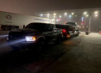 Custom trucks at Trendsetters Customs workshop at night.