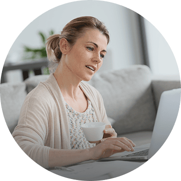 Woman using eco-friendly cleaning products at home for a healthier environment.