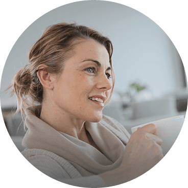 Woman enjoying a clean and fresh home after Texas Green Clean services.