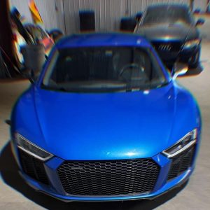 Blue sports car with sleek design and aerodynamic features.