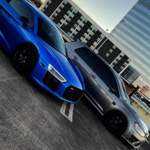 High-performance custom tuned cars in an urban setting.
