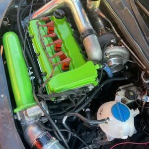 High-performance engine with vibrant green components for enhanced power and efficiency.