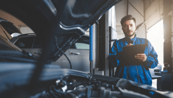 Skilled auto repair technician diagnosing engine issues at Uncle D’s Transmissions & Auto Repair.