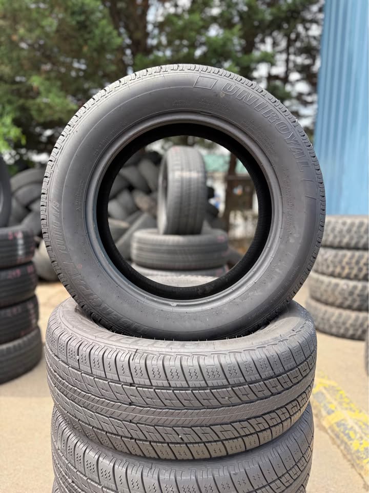 Stacked used tires at Universal Tire Tire Center for sale or installation.