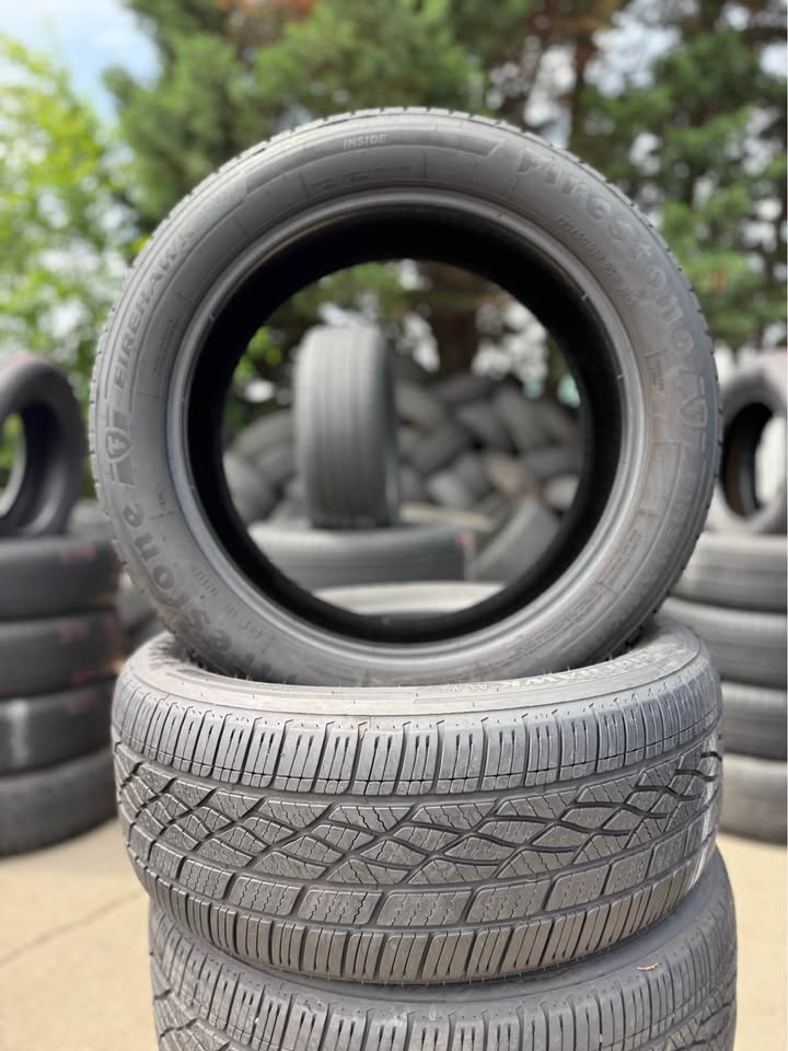 Stacked used tires at Universal Tire Tire Center for sale or installation.