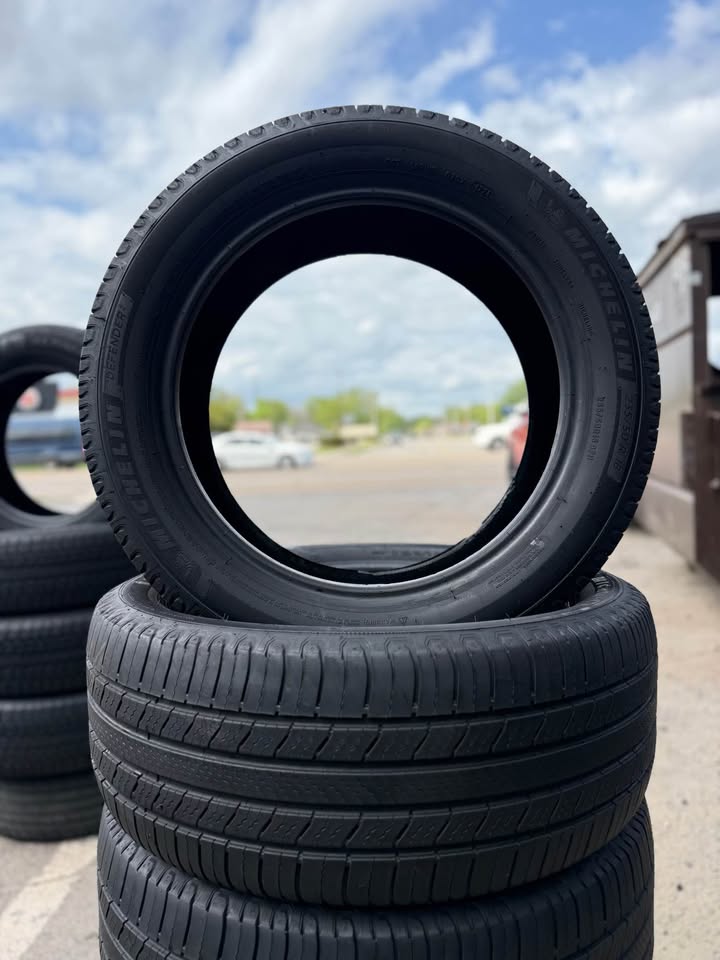 Stacked used tires outside Universal Tire Tire Center for sale.