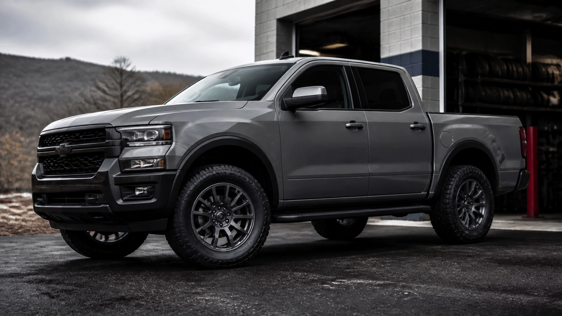 Gray pickup truck parked outside Universal Tire Tire Center for tire service.