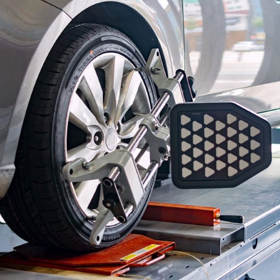Tire alignment machine performing wheel alignment on a vehicle at Value Tires & Service.