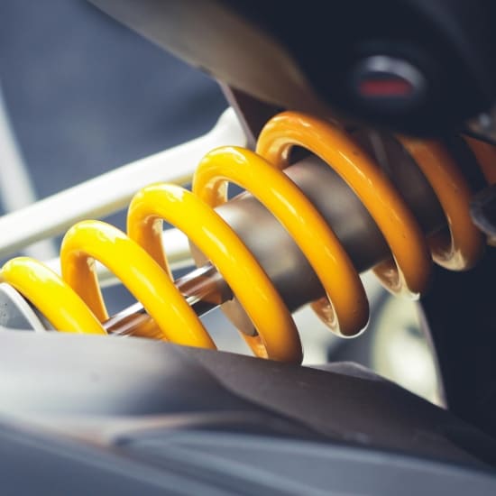 Suspension coil on motorcycle shock absorber for smooth ride and vehicle stability.