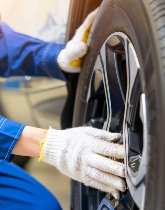 Technician installing a car tire at Value Tires & Service, professional auto repair.