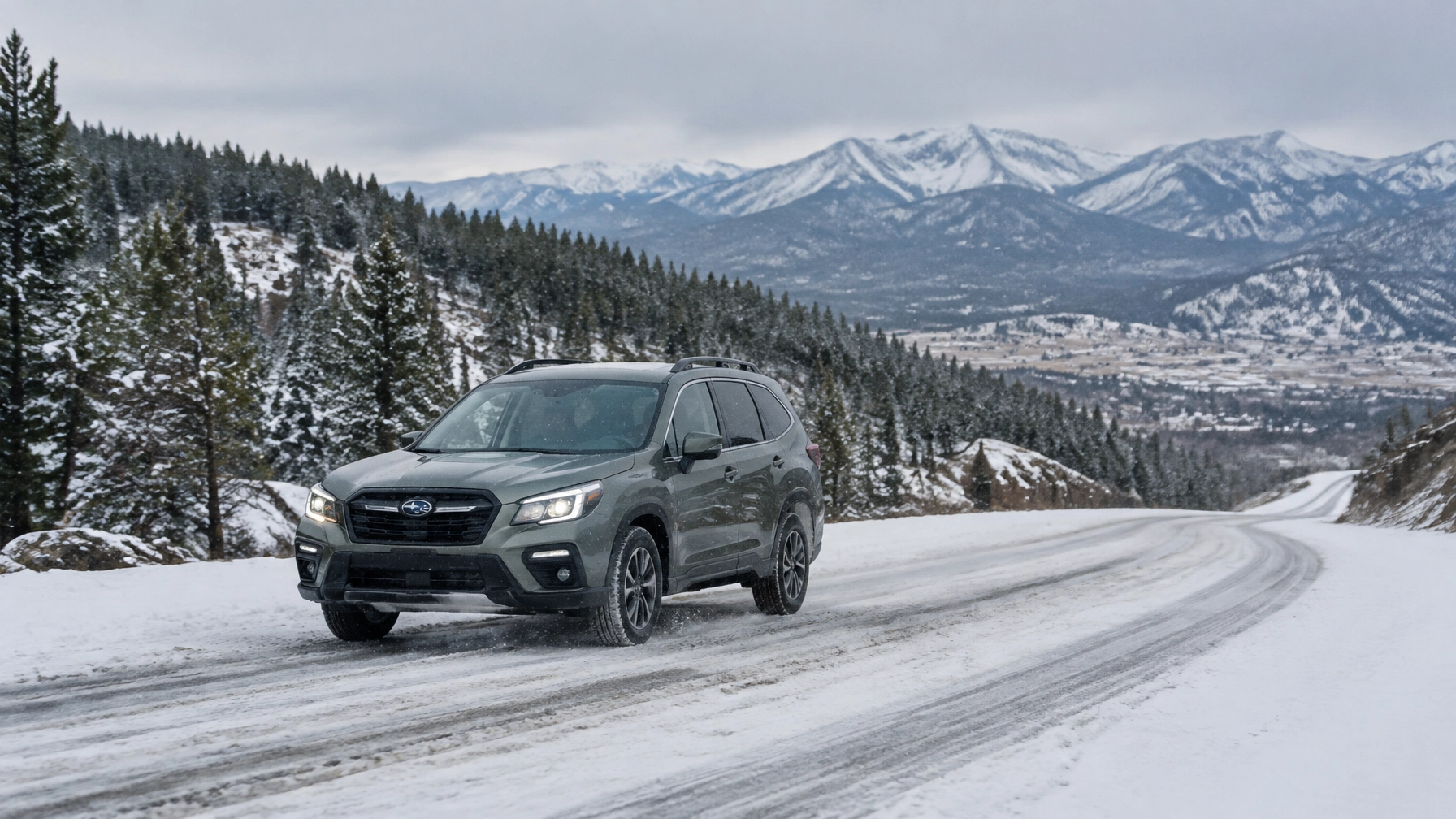 Black SUV driving on snowy mountain road with pine trees and snow-capped peaks.