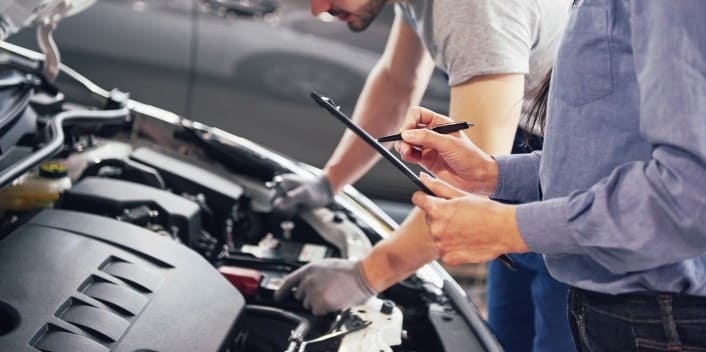 Automotive engine repair service at Wallace Automotive, expert technicians working on a vehicle engi.