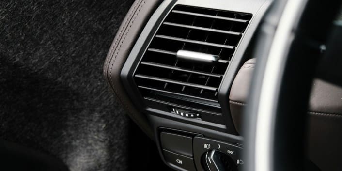 Air vent in a modern vehicle interior for optimal climate control.
