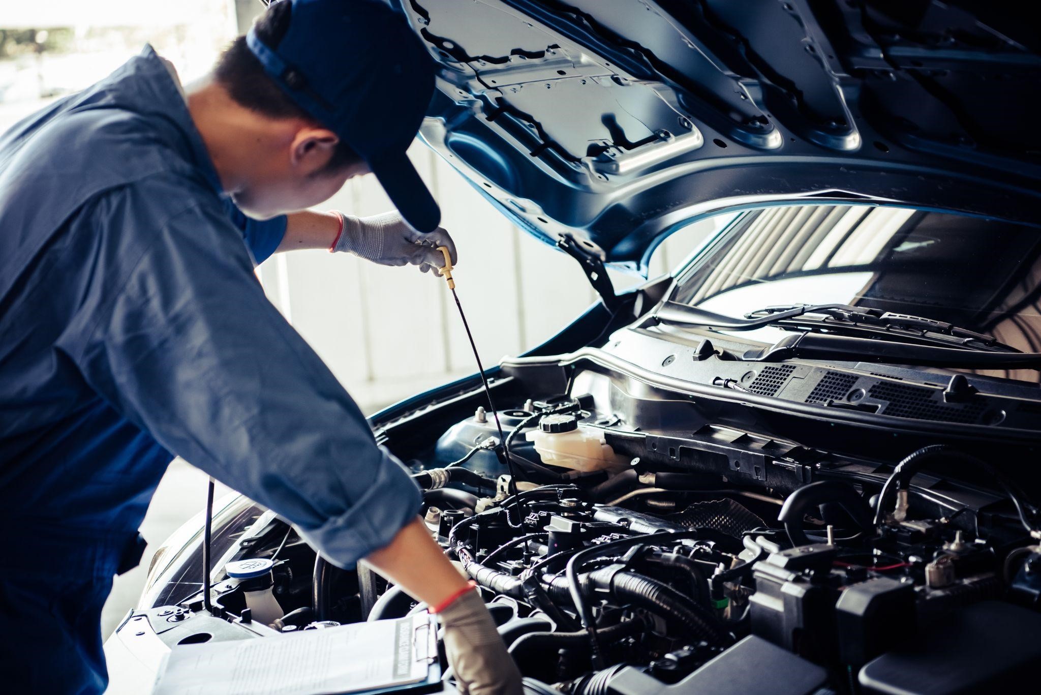 Mechanic Checking Oil