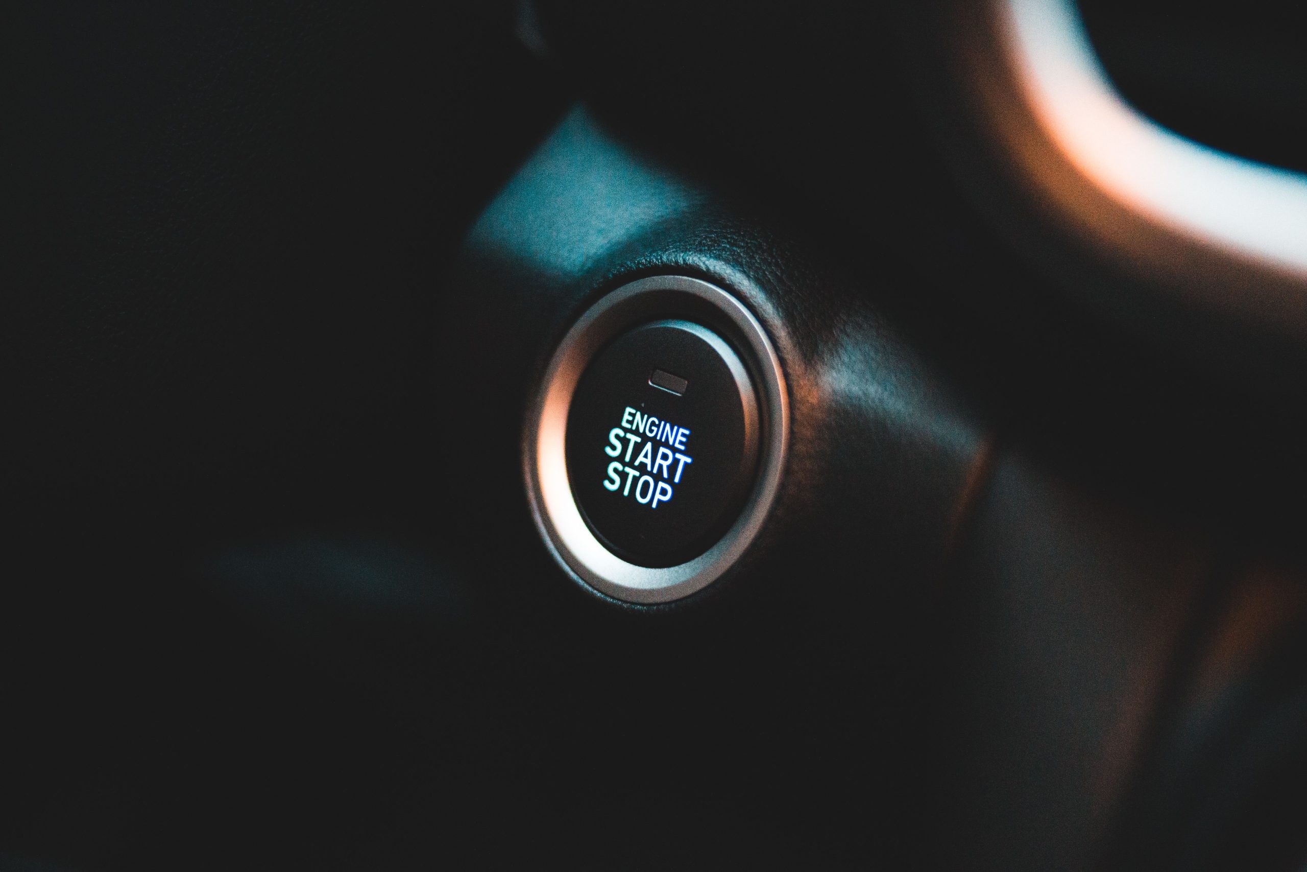 Close-up of engine start/stop button in a Toyota or Lexus vehicle.