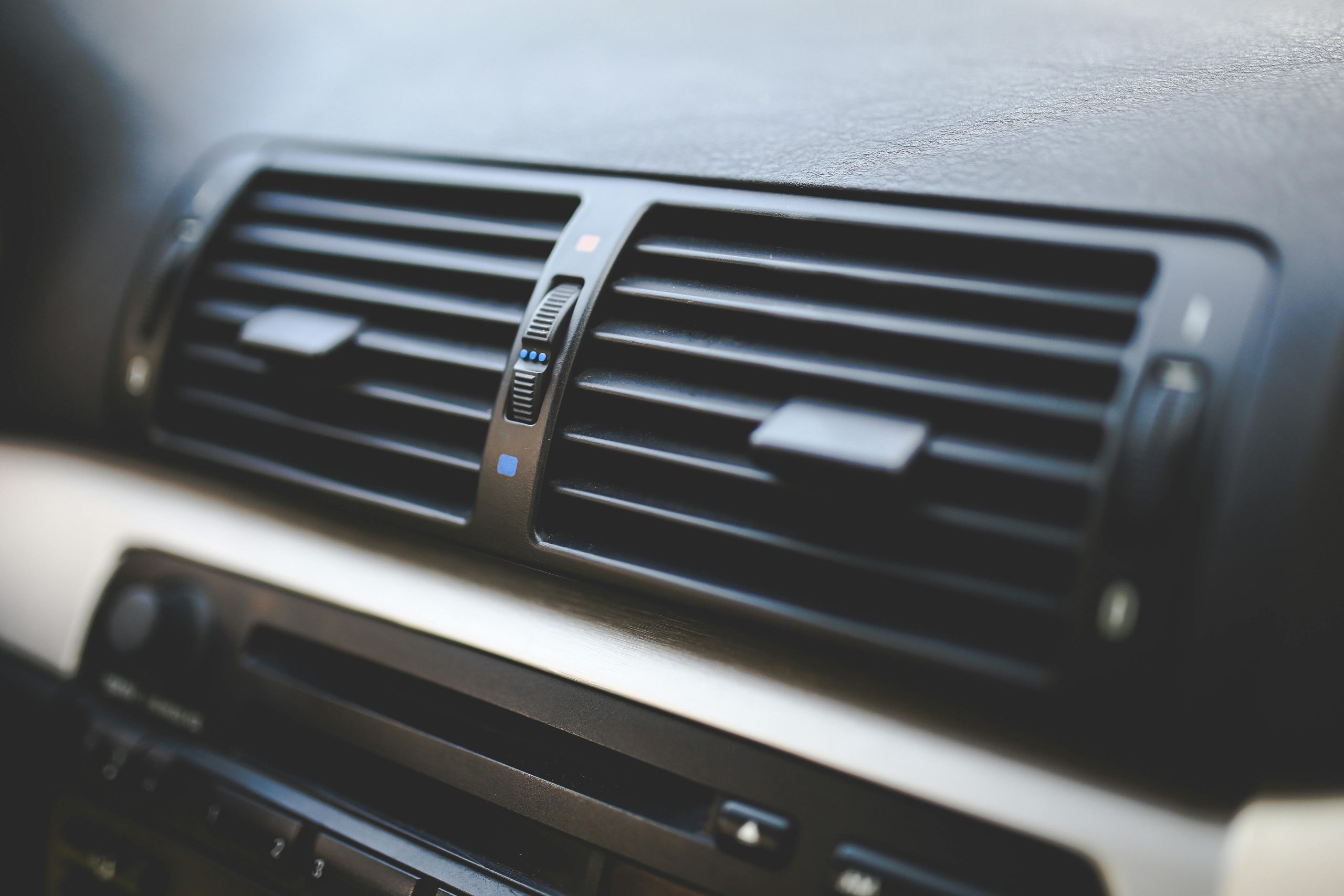 Air conditioning vent in a car dashboard for climate control.