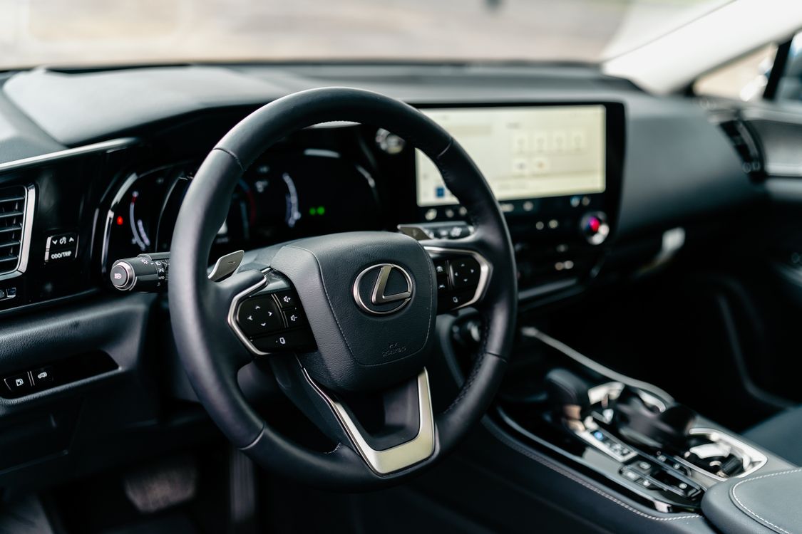 Interior view of a Lexus vehicle showing steering wheel and dashboard.