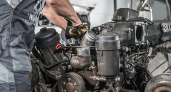 Technician working on truck engine repair at Wilsons House of Automotive.