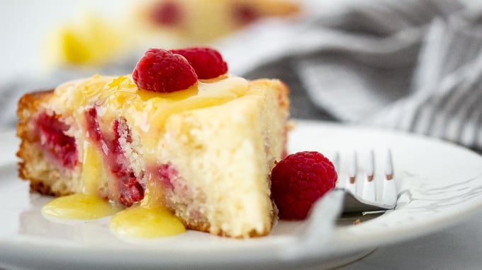 a picture of raspberry ricotta cake topped with lemon curd glaze