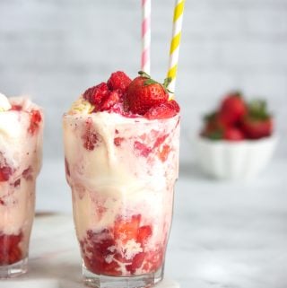 A strawberry float with macerated chopped strawberries, lime soda and vanilla ice cream topped with a strawberry