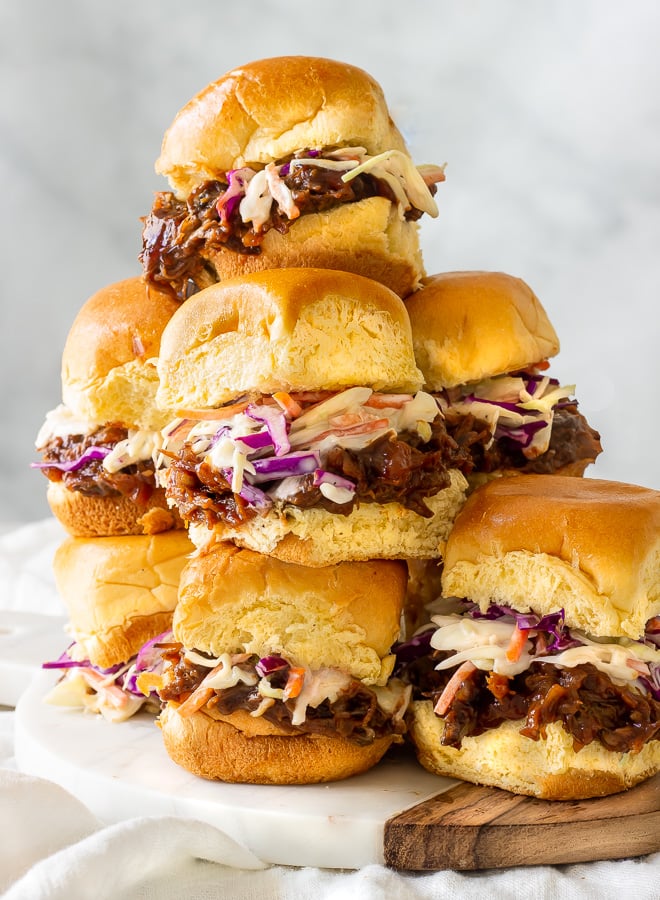 A plate of slow cooked bbq pulled beef inside of hamburger buns