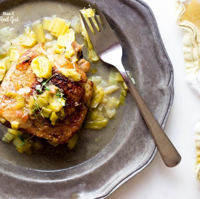 Savory, tart, and tender crispy chicken thighs are braised then baked in a leek cider sauce. This dish is lovely served with brown basmati rice or mashed potatoes. A perfect easy Autumn one pot meal! Ready in 35 minutes or less!