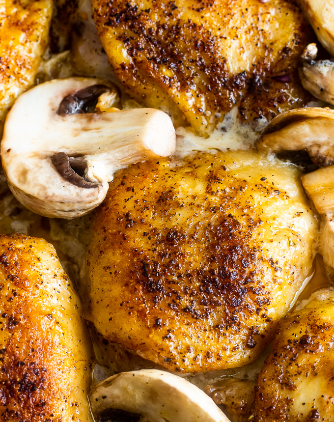 a serving dish with smothered chicken and bok choy