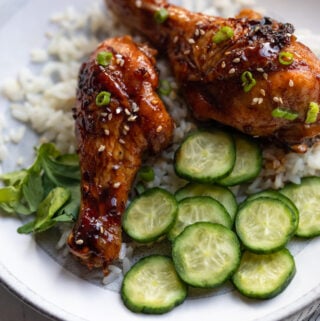 A plate of teriyaki chicken legs