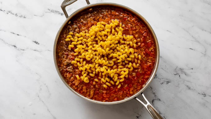 Pasta with the taco mix and water in a skillet 