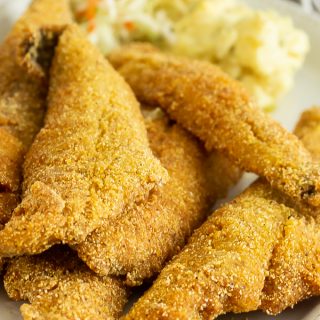A plate of several pieces of fried whiting fish