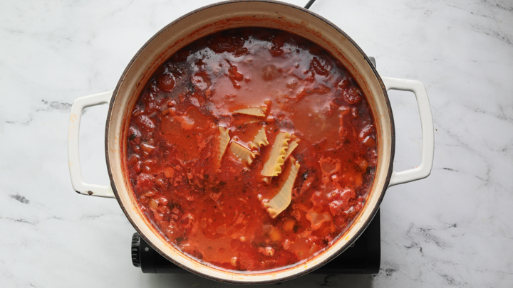 A picture of lasagna soup in a dutch oven 