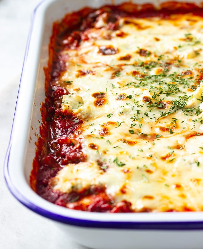 A plate of baked ravioli lasagna with meat sauce 