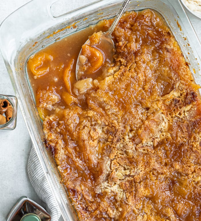 A picture of a baking dish with peach cobbler with crust