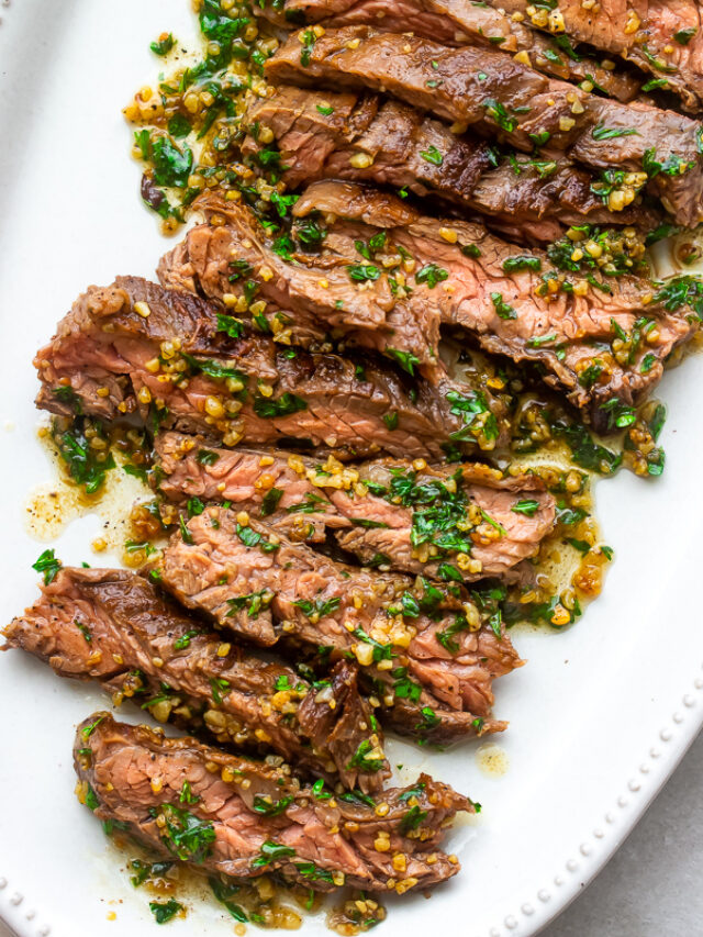 A plate of juicy tender Brazilian Steak with garlic butter drizzled on top