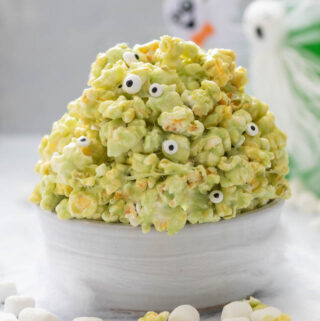 A picture of bowl of slime popcorn with candy eyeballs