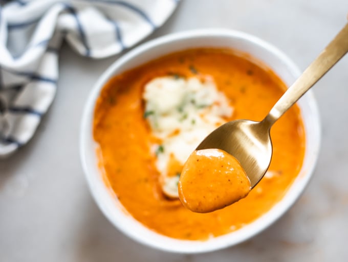 A picture of spoonful of tomato bisque