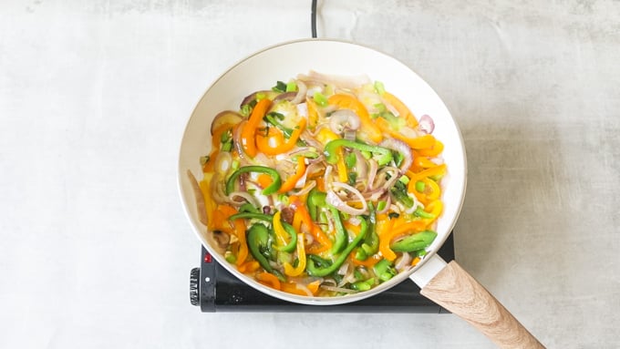 cooking peppers in a skillet