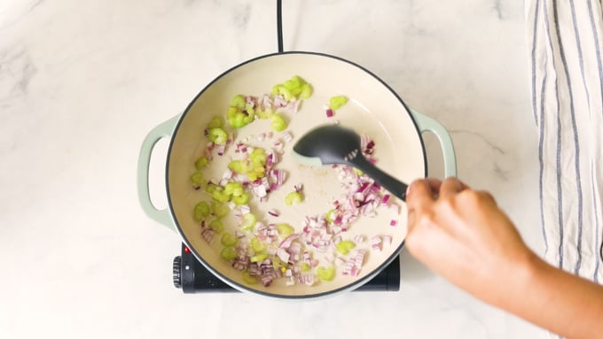 Sauteeing onions and celery in a pot